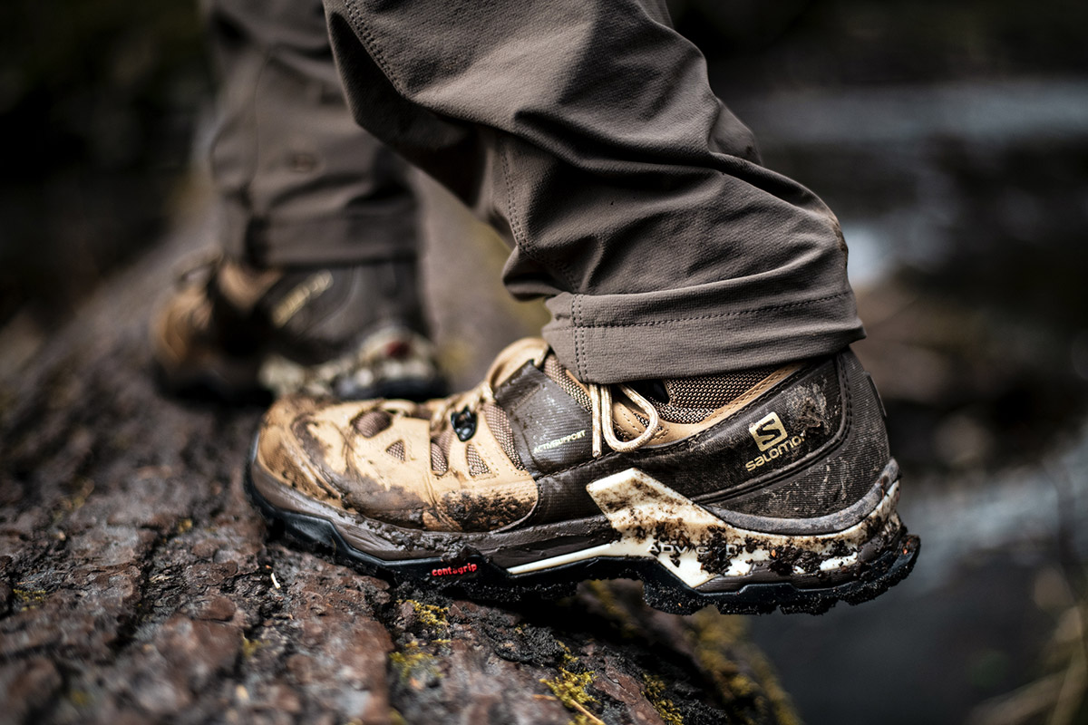 Salomon Quest 4 GTX hiking boot (men's version gripping over wet log)